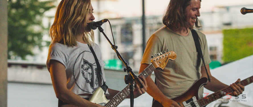 2 Musicians Who Gambled Too Much two musicoan playing guitar on street for performance - 2 Musicians Who Gambled Too Much